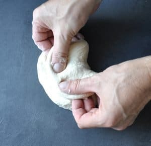 kneading Indian flatbread dough, roti, naan, chapati or paratha