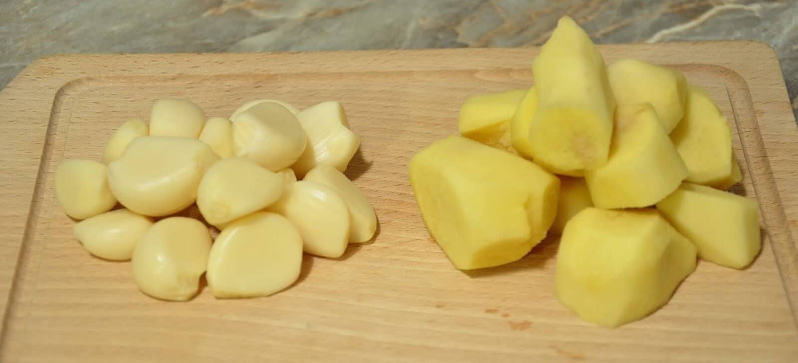 peeled ginger and garlic on wooden board