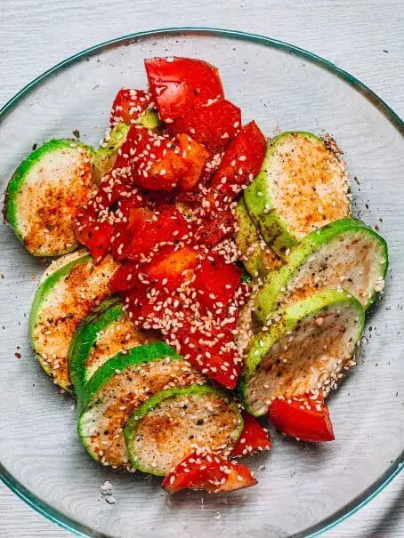 Vegetarian or vegan pan roasted giant zucchini with red bell pepper and sesame