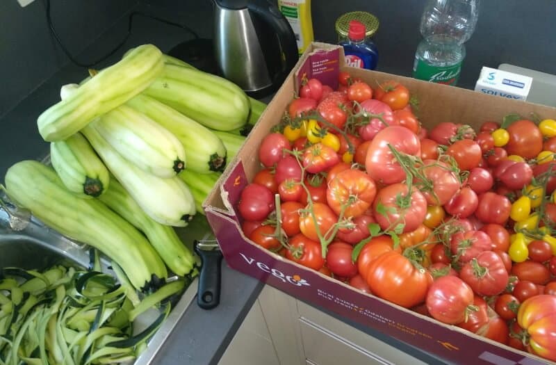 a lot of overgrown courgettes or zucchini peeled with tomatoes