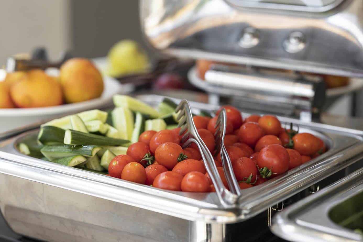 zucchini and cherry tomatoes in chafing dish