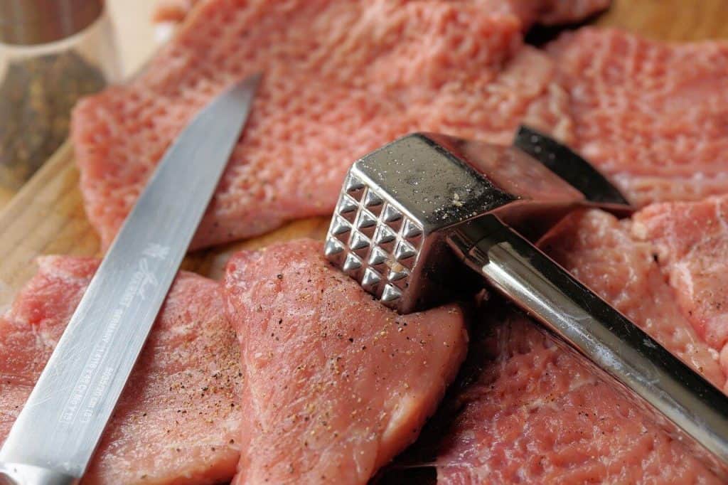 meat mallet tenderizing meat