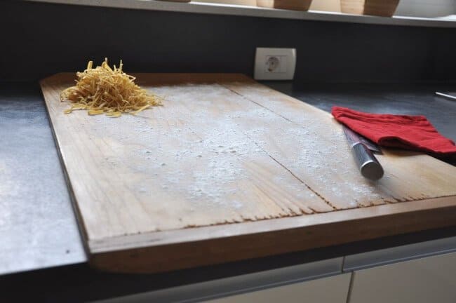 pasta board with noodles and chefs knife