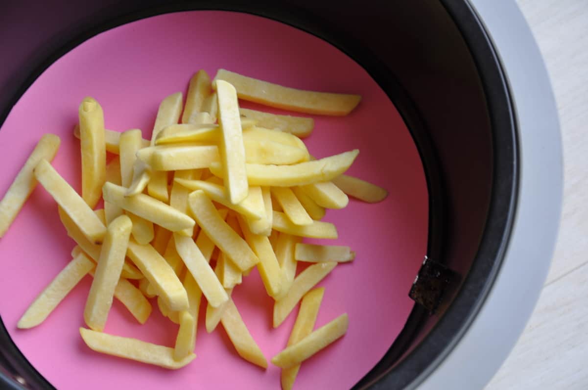 silicone baking mat with fries in an air fryer