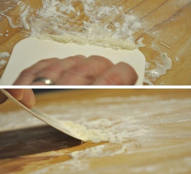 cleaning and scrapeing off dough from pasta board