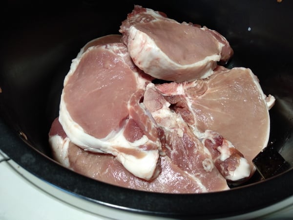 Pork chops stacked in a basket airfryer