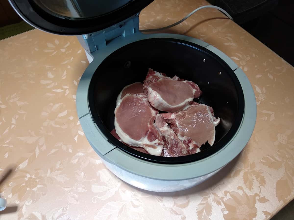 Stacked pork chops in a basket airfryer