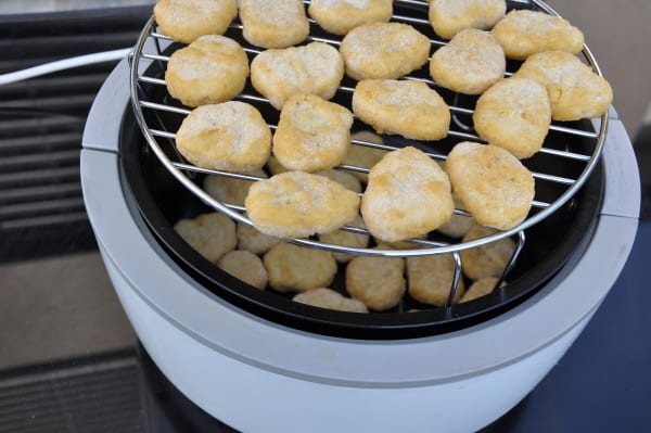 Stacked chicken nuggets in an air fryer with a rack