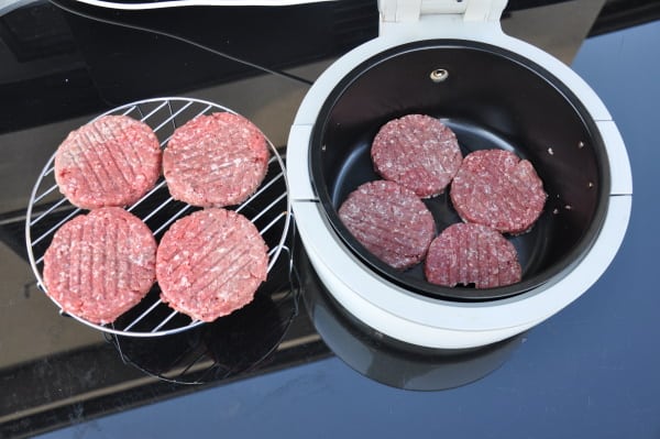 stacking burgers in an air fryer on a rack and in the basket