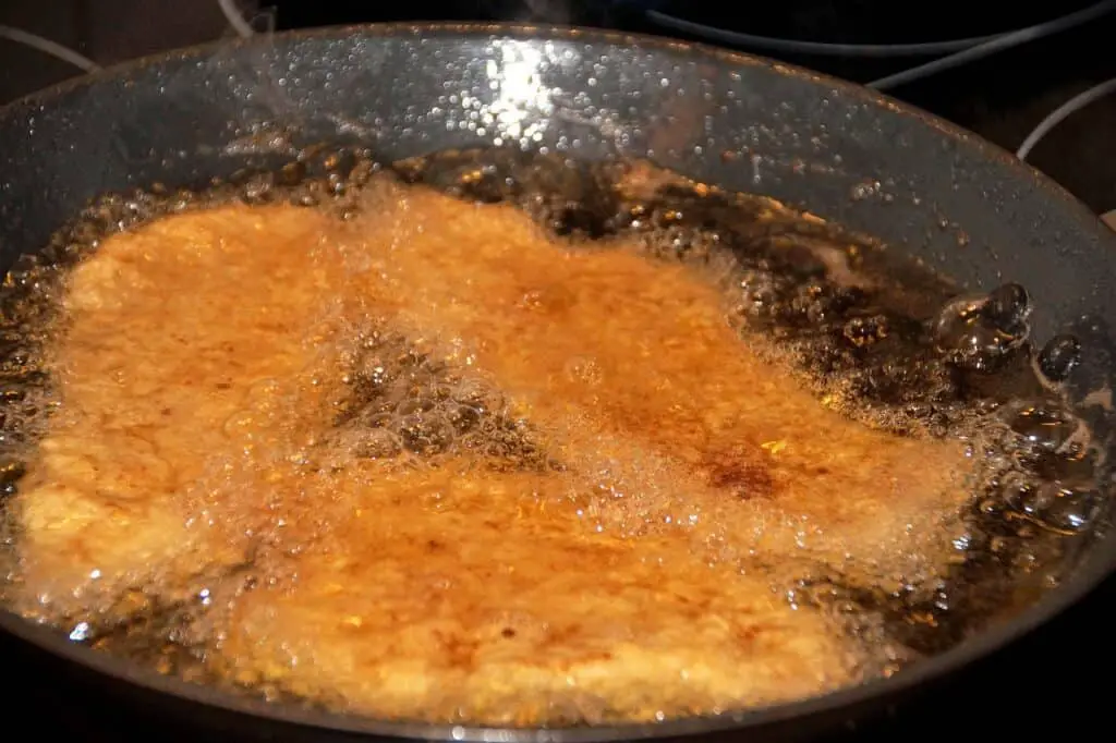 hot cooking oil frying breaded steaks