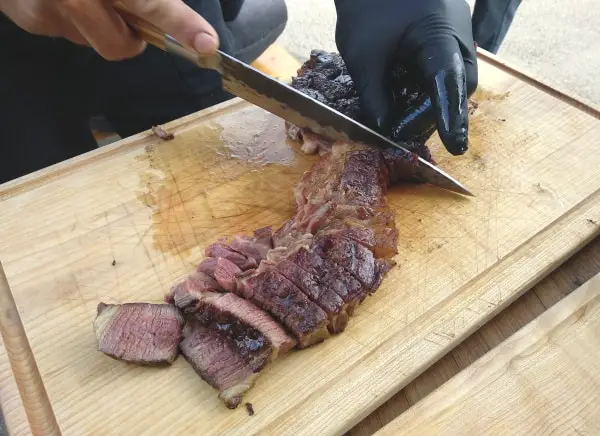 Cutting medium rare beef steak