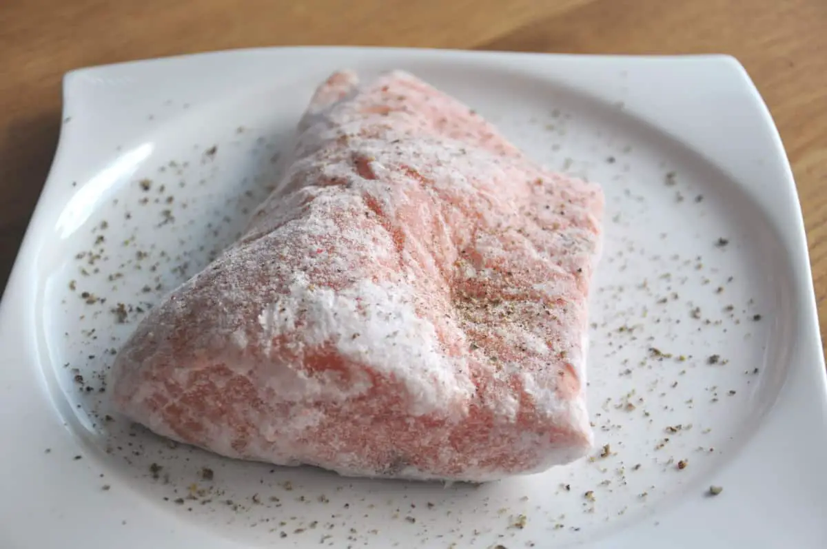 dry rub and seasoning on frozen salmon