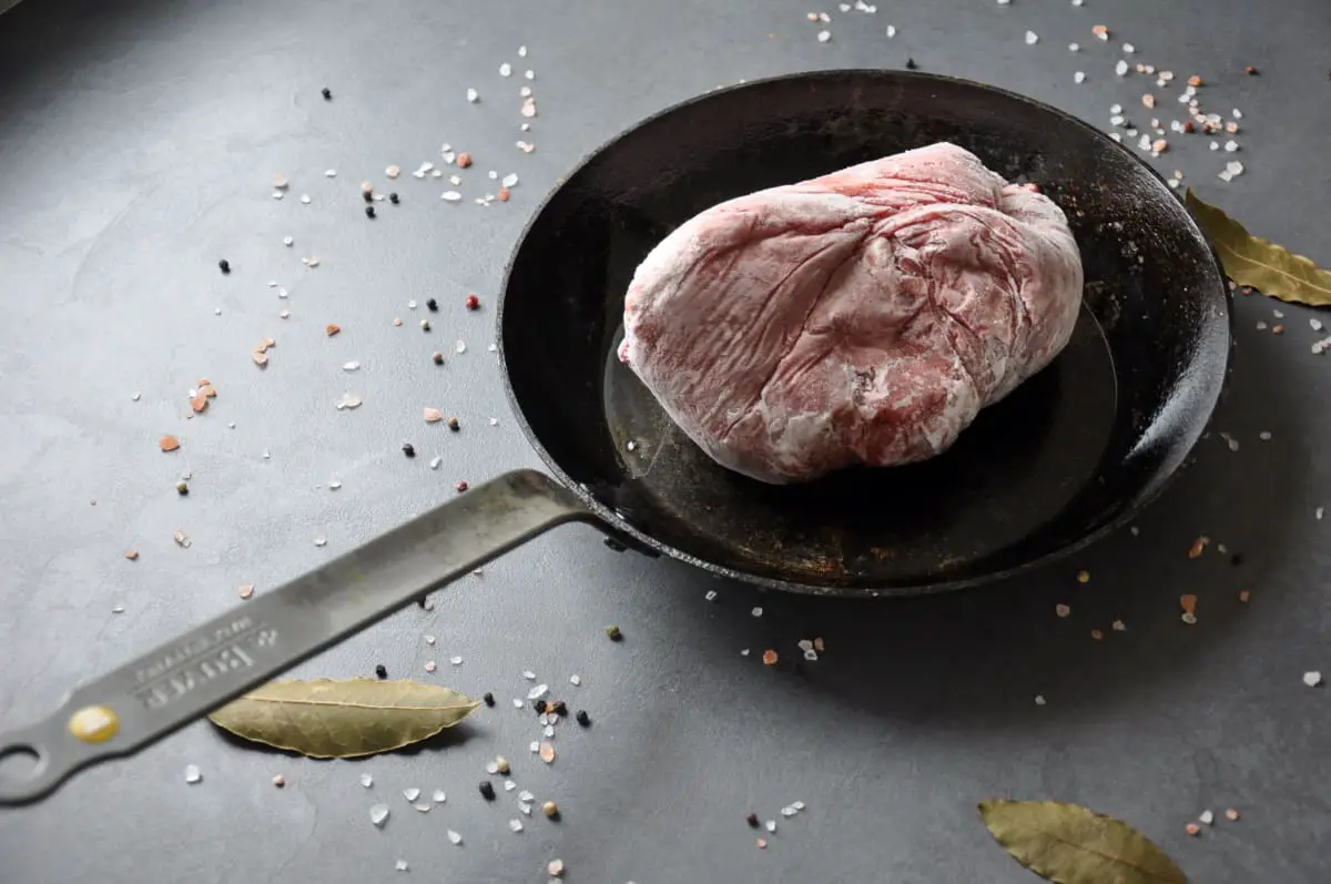 seasoned frozen beef round ready for searing