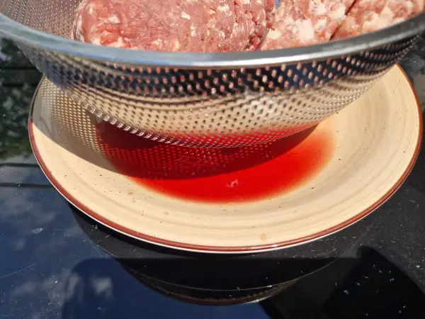 Stainless steel colander with draining tray for meat juices