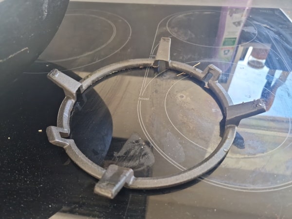 cast iron wok ring on glas stove